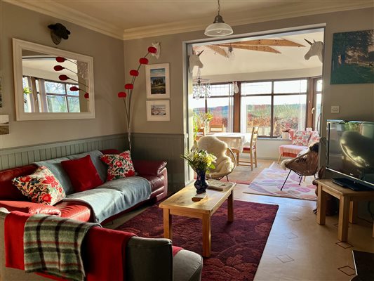 The open plan sitting area between the kitchen and sun lounge